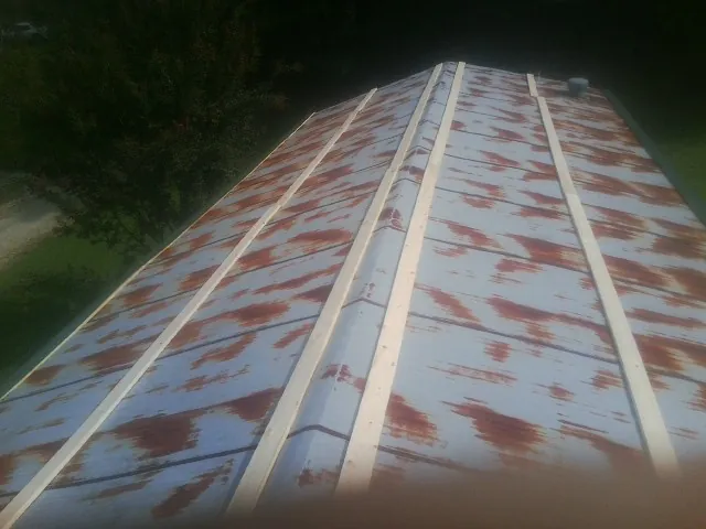 Rusted metal roof panels with new wood purlins before replacement — Storm Damage Roof Repair in Albert by Roofing Brothers